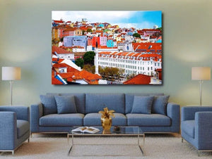 Modern living room with blue sofas, cityscape wall art, and soft lighting