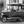 Classic vintage car parked on cobblestone street in black and white