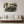 Vintage car black and white wall art above modern beige sofa in a minimalist living room