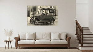 Vintage car black and white wall art above modern beige sofa in a minimalist living room
