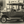 Vintage black and white photo of classic antique car parked on cobblestone street