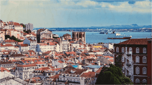 Scenic cityscape with red-roofed buildings, historic cathedral, and blue river under cloudy sky