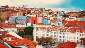 Colorful Lisbon cityscape with red rooftops, historic buildings, and a central monument