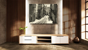 Modern living room with minimalist TV stand and black and white street photograph on wall