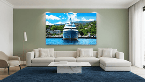 Modern living room with large yacht wall art, neutral sofa, blue rug, and green accent wall.