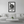 Modern living room with white sofa, framed black and white statue photo on wall, minimalist decor