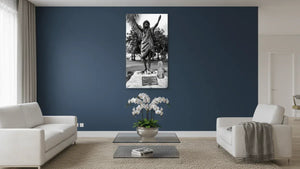 Black and white Polynesian statue art on wall in modern living room with blue accent wall.