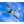 Seabird in mid-flight against a vibrant blue sky with scattered clouds