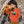 Girl in orange eco-friendly kids hoodie with hermit crab print, outdoor background