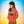 Child wearing orange eco-friendly hoodie with crab and shell print, gradient background