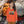 Child wearing orange eco-friendly hoodie with hermit crab print, outdoors