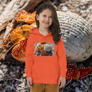 Child wearing orange eco-friendly hoodie with hermit crab print, outdoors