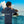 Child wearing navy ecological hoodie with 'I am wise!' text, standing by tropical water and boat.