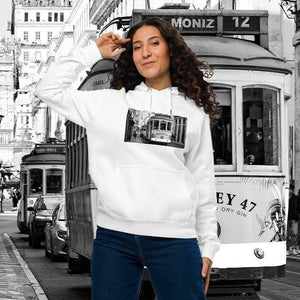Woman wearing white eco-friendly raglan hoodie with vintage tram print, city street background