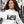 Woman wearing white eco-friendly unisex raglan hoodie with black and white streetcar photo print