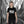 Child wearing black organic cotton t-shirt with tram street photo print, city street background