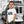 Child wearing white organic cotton t-shirt with tram print, city street background