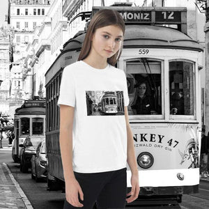 Girl wearing white organic cotton t-shirt with black and white tram print, urban background.
