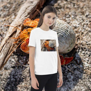 Girl wearing white organic cotton t-shirt with hermit crab nature print, outdoor style