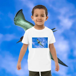 Child wearing organic cotton t-shirt with bird print, blue sky background, kids fashion