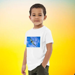 Boy wearing organic cotton kids t-shirt with flying dinosaur print on white background
