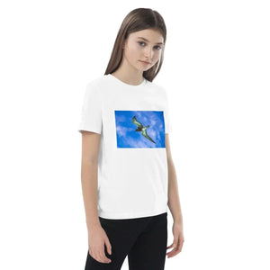 Girl wearing white organic cotton t-shirt with flying dinosaur print on the front