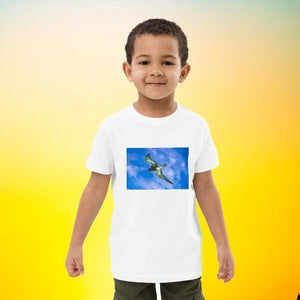 Child wearing organic cotton t-shirt with flying pterosaur print on white background