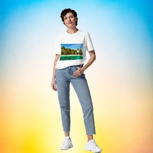 Woman wearing organic cotton unisex t-shirt with tropical beach print, casual jeans, sneakers.
