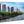 Tableau décoratif mural en plexiglas représentant le Front de Seine à Paris, ses immeubles modernes, ses arbres et les reflets de l’eau