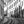Black and white urban street photo with tram tracks, old buildings, and people walking