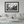 Modern living room with white sofa and a large framed black and white urban street photography print on the wall.
