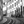 Black and white photo of curved streetcar tracks in a European city with people walking