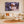 Modern living room with cream decor, coastal view, and wall art featuring hermit crabs in shells