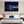 Modern bedroom with a night cityscape wall art above bed, cozy decor and pendant lights