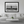 Modern living room with framed black and white photo of beach, man, and sailboat on wall