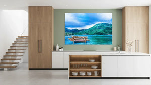 Modern kitchen with wall art of a scenic boat on blue water and lush green island landscape.